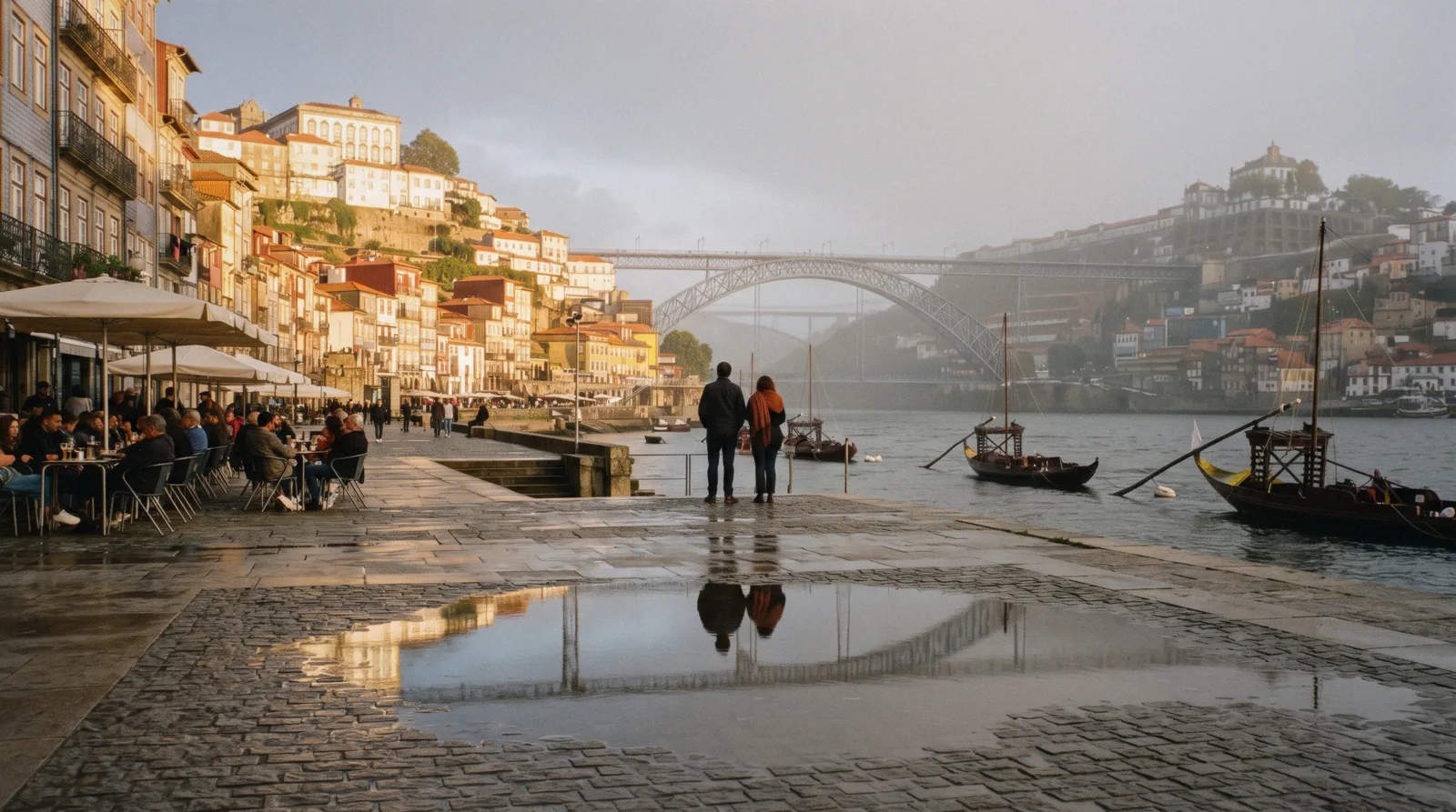 The Ribeira quay and the Luís I bridge under a clearing sky at 09:10 in late May, wet cobbles drying in the sun, the month most readers pick as the best time to visit Porto