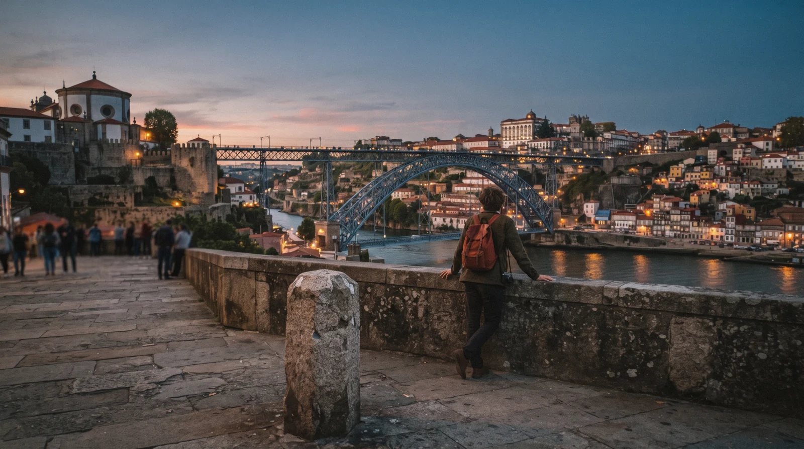 A traveller on the Serra do Pilar terrace at seven in the evening looking across the Douro at the bridge and the Ribeira, weighing whether Porto is worth visiting