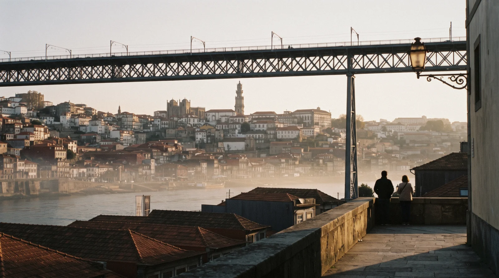 The Gaia lodge roofs and the upper deck of the Luís I bridge seen from the Serra do Pilar terrace at 18:20, the second afternoon of Porto in 2 days