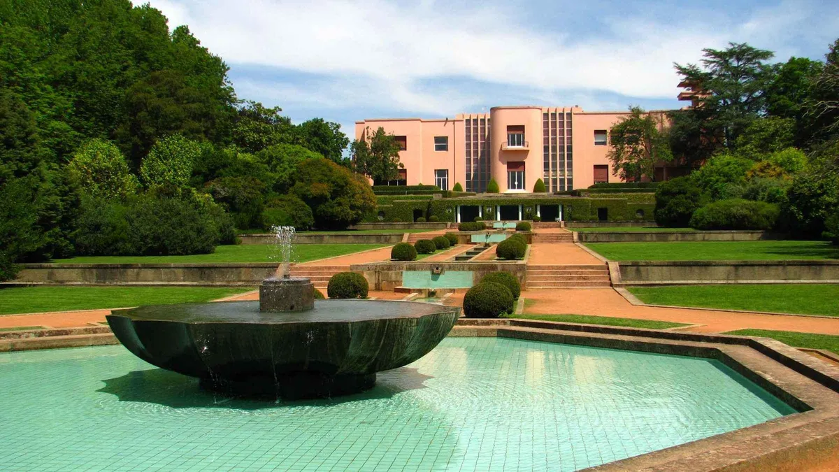 The white Art Deco villa of the Serralves Foundation seen across its formal garden, last stop on a Porto, Portugal must-see list