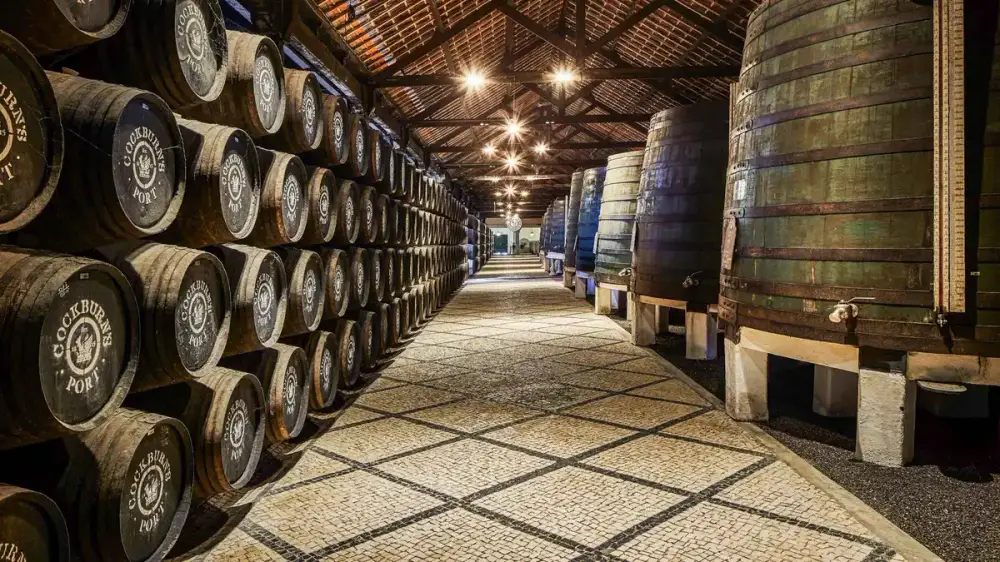 Rows of oak port barrels inside the Cockburn's cellar in Vila Nova de Gaia, Porto