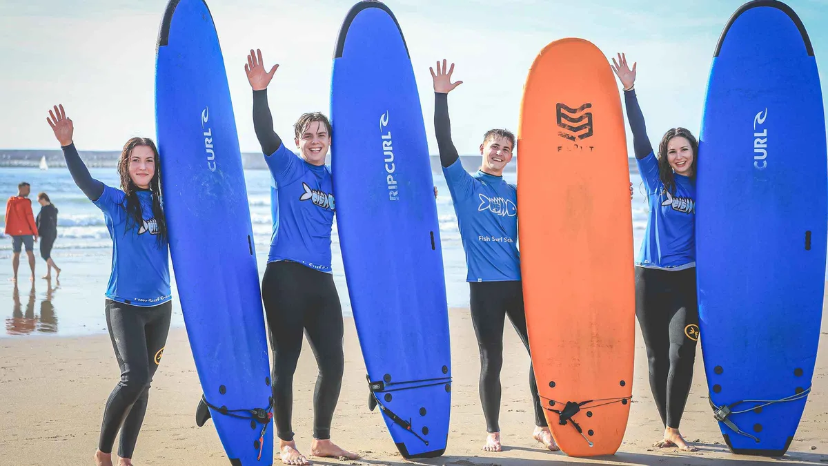 Surf students holding boards upright on the beach at Matosinhos near Porto