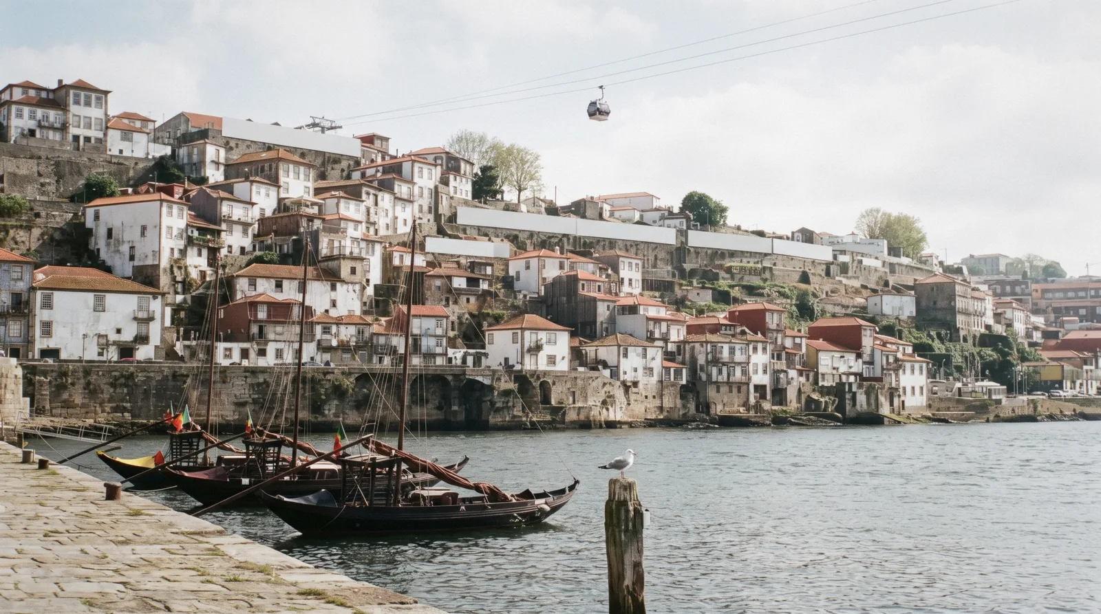 The port wine lodges of Vila Nova de Gaia and the rabelo boats moored below them, across the Douro from Porto, Portugal