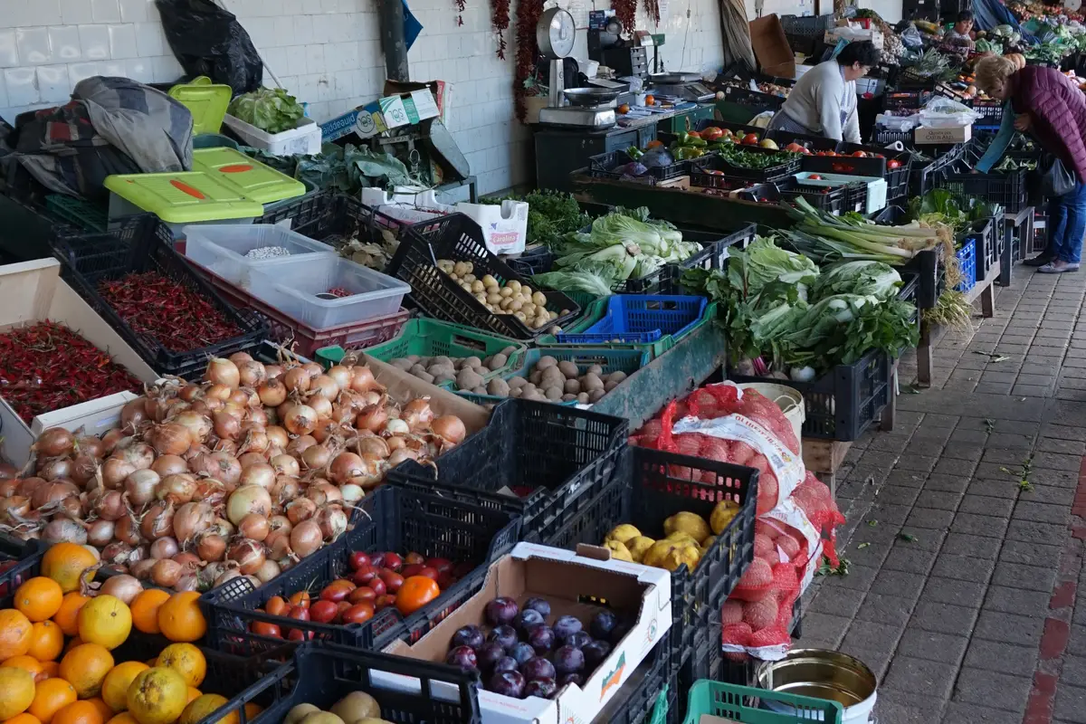 Crates of oranges, onions and peppers on a produce stall at the Mercado do Bolhão, the fresh market of Porto