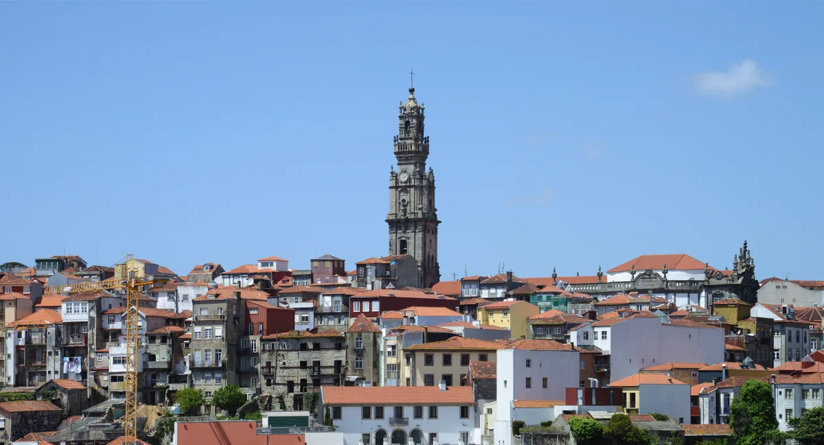The Torre dos Clérigos rising above the terracotta rooftops of the Baixa in Porto on a clear spring day